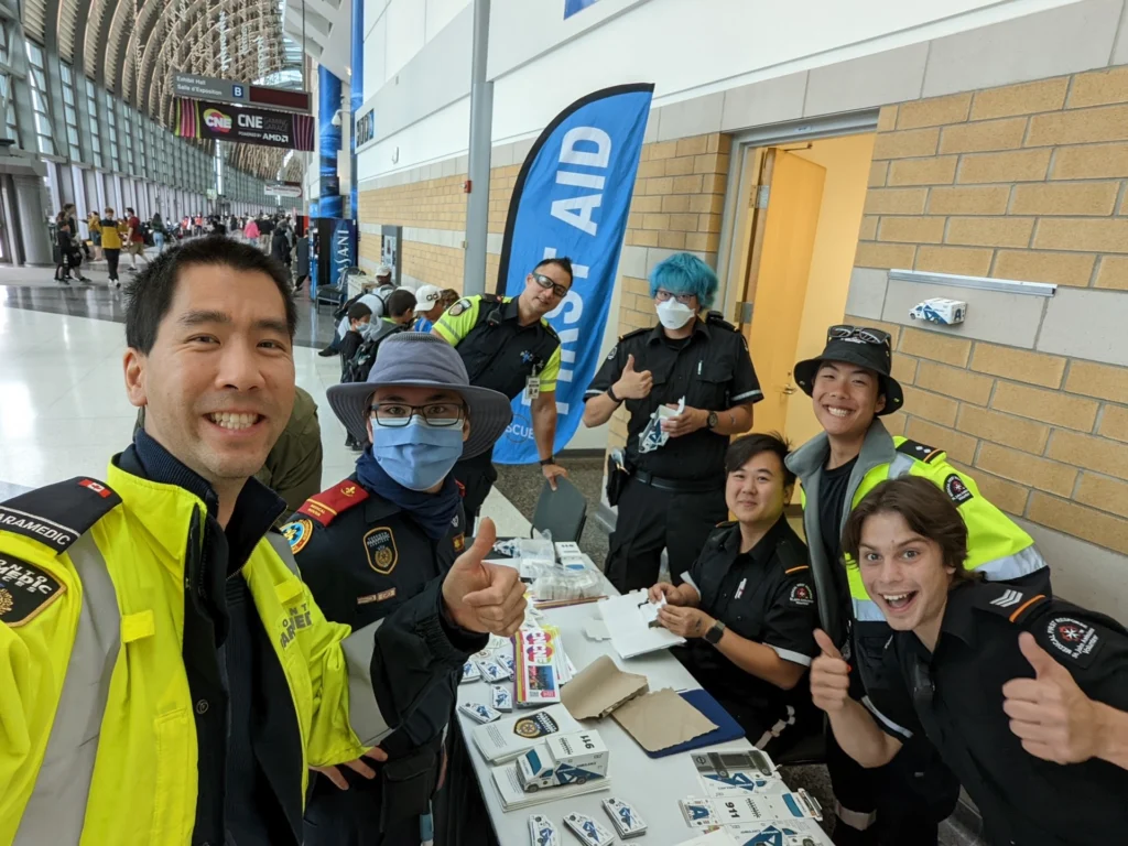 Cameron Prosic (front right, thumbs up) in his St. John Ambulance uniform with fellow first-aid volunteers and paramedics at the CNE